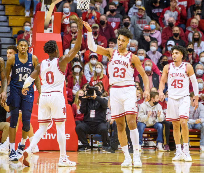 Trayce Jackson-Davis high fives Xavier Johnson.